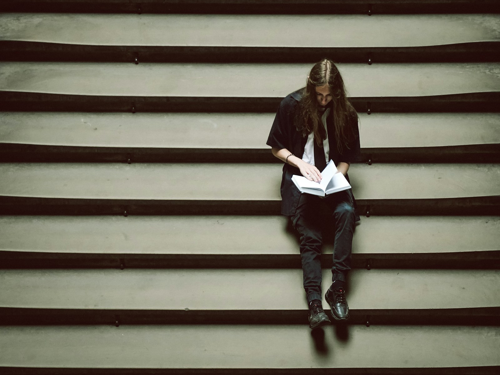A person sitting on a set of stairs